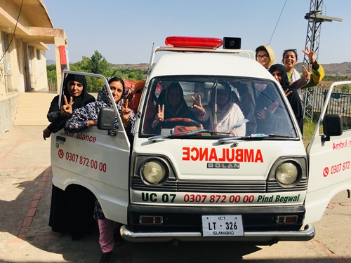 A picture of women standing around the meseeha ambulance