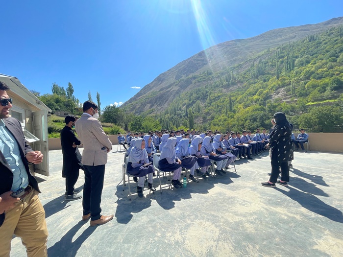 Outdoor classrooms with girls sitting in rows 